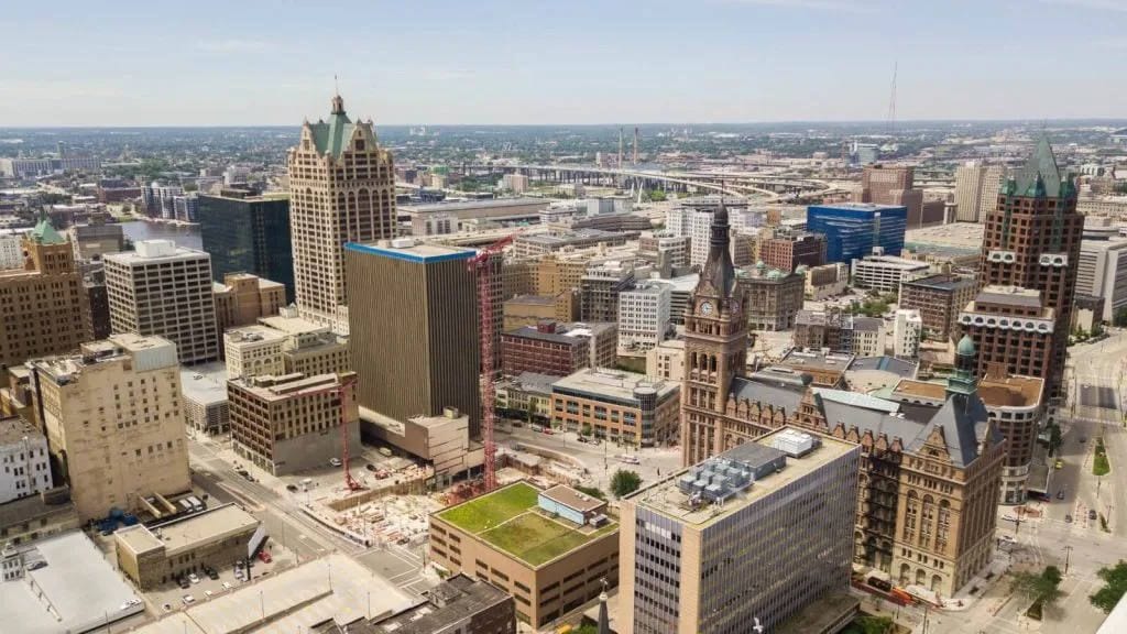 Aerial view of downtown Milwaukee with City Hall's clock tower and surrounding office buildings