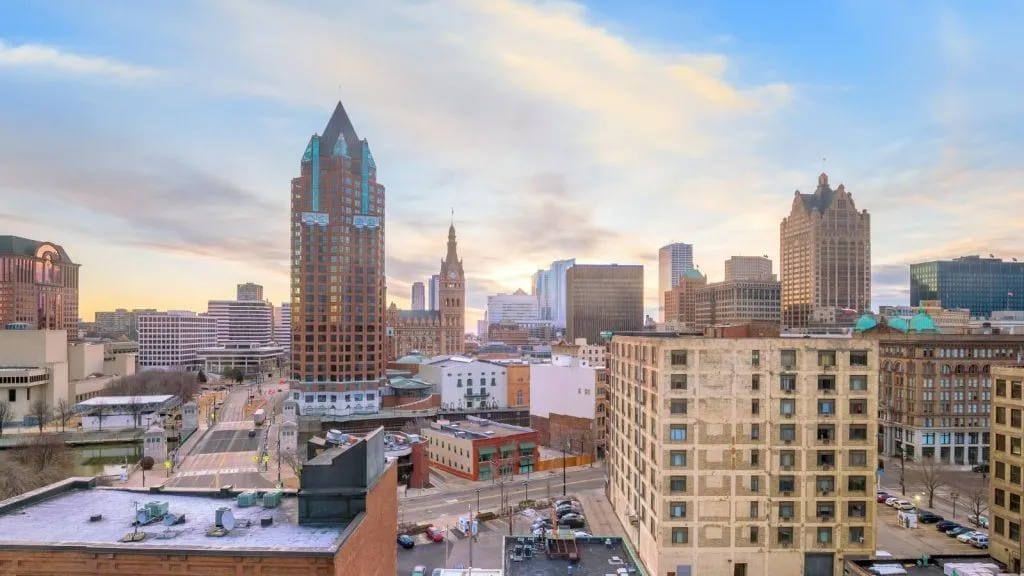 Downtown Milwaukee skyline at sunset with high-rise towers and apartment buildings